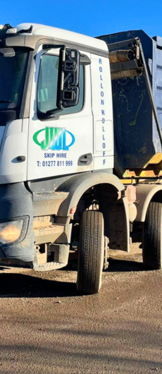 JWL Services Ltd skip lorry in action, prominently featuring the JWL logo on its side, showcasing efficient waste removal services in Essex.